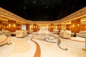 a large room with a lobby with couches and tables at Sakab Al Hijaz Hotel in Makkah
