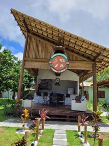 a large wooden pavilion with a table and chairs at Bons Ventos Camping e Glamping in Barra Grande