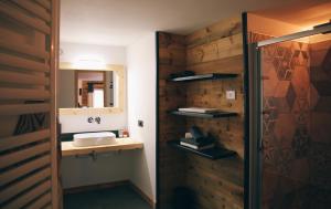 a bathroom with a sink and a mirror at Maison Farinet in Saint-Rhémy-en-bosses