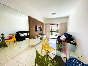 a living room with a glass table and chairs at Beverly Hills por Be My Guest in Aquiraz