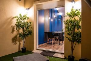 a room with a view of a table with a chair at BLUE NIGHT - Jacuzzi - Bord de Seine in Corbeil-Essonnes