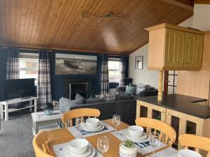 a living room with a table and a couch at Lake View Lodge in Millom