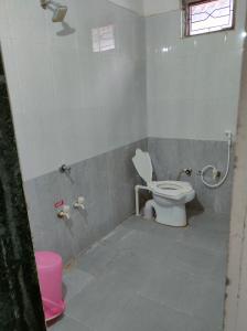 a bathroom with a toilet and a shower at Gir Ganesh Farm & Resort in Sasan Gir
