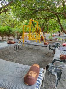 a park with a playground with a swing at Gir Ganesh Farm & Resort in Sasan Gir