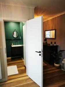 uma porta aberta para uma casa de banho com um lavatório em Dagmars Apartment em Steinwenden