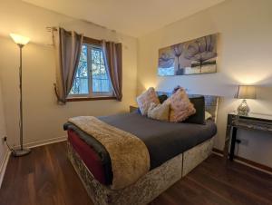 a bedroom with a bed and a window at Hayloft at Bonnyside House in Bonnybridge
