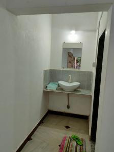 a bathroom with a sink and a mirror at Gir Ganesh Farm & Resort in Sasan Gir