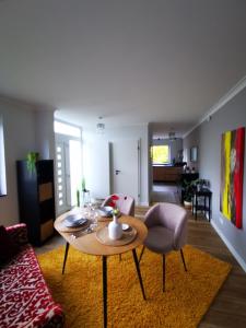 a living room with a table and a couch at Dagmars Apartment in Steinwenden