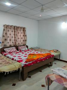a bedroom with two beds in a room at Gir Ganesh Farm & Resort in Sasan Gir