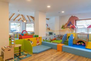a childrens play room with colorful furniture at Resort Dolce Casa - Family & Spa Hotel in Moena