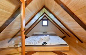a bed in the attic of a wooden house at Stunning Home In Klostar Ivanic With Sauna in Kloštar Ivanić