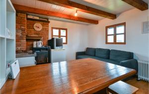 a living room with a table and a couch at Stunning Home In Klostar Ivanic With Sauna in Kloštar Ivanić