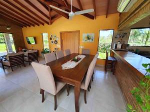 a dining room with a wooden table and chairs at Casa con Piscina, Quincho, Cancha de Futbol/Volley in San Bernardino