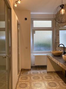 a bathroom with a sink and a window at Minimal Hostel No.43 in Berlin