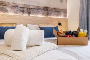 a bedroom with a bed with a box of food at Mara Boutique Apartments in Benidorm
