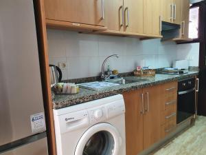 a kitchen with a washing machine and a sink at Marina Beach in Puerto de la Cruz