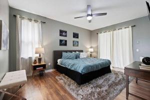 a bedroom with a bed and a ceiling fan at Spacious Disney Themed 5Bed Villa! Private Heated Enclosed Pool/Spa/BBQ! in Davenport