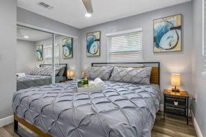 a bedroom with a large bed in a room at Cozy & Fully Renovated FREE Heated Pool Home! in Largo +62 photos
