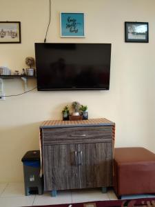 a flat screen tv hanging on a wall at MBI Homestay, Wakaf Che Yeh Kota Bharu in Wakaf Che Yeh