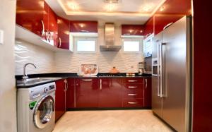 a kitchen with red cabinets and a washer and dryer at Cruz Hyper centre 4 or 5 Px in Agadir
