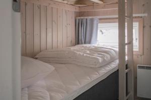 a bedroom with a bunk bed and a window at First Camp Edsvik-Grebbestad in Skickeröd