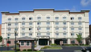 a large white building with a stop sign in front of it at The Marx Hotel - Downtown - University Area in Oneonta