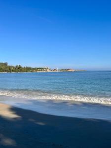 a view of the beach with the ocean in the background at Peninsula Esmeralda Luxury Villas in San Felipe de Puerto Plata