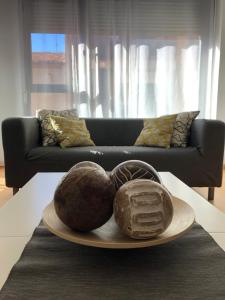 a plate with two coconuts on a table with a couch at Apartamentos Ribera Navarra - Bardenas in Castejón