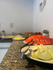 a table with plates of food on a counter at Pousada Mar de Maceió in Maceió