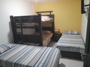 a room with two bunk beds and a bed at CASA FLOR DE LIZ in Villavieja