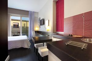 a hotel room with a bed and a bathroom at Sorrento Apartments in Sorrento