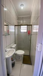 a small bathroom with a toilet and a sink at Apartamentos PraiaMar in Ilha Comprida