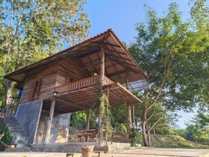 a wooden house with a roof on top of it at 467 Chiang Dao in Chiang Dao