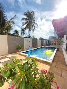 a pool with a water slide on top of a building at JACY AP GOSTOSO in São Miguel do Gostoso