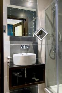 a bathroom with a sink and a shower at Montcalm Marble Arch Townhouse in London