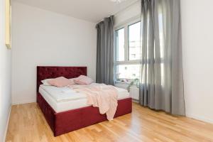 a bedroom with a bed and a large window at ShortStayPoland Sikorskiego (B103) in Warsaw