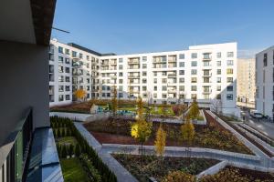 an apartment complex with a garden in front of a building at ShortStayPoland Sikorskiego (B103) in Warsaw