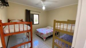 a bedroom with two bunk beds and a bed at Apartamentos PraiaMar in Ilha Comprida