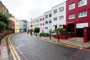 an empty street in a city with colorful buildings at Veeve - Village Virtuosity in London