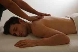 a man laying on a bed getting a massage at Real Intercontinental San Salvador by IHG in San Salvador +208 photos