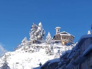 a house on top of a snow covered mountain at Mini House Tagliacozzo in Tagliacozzo