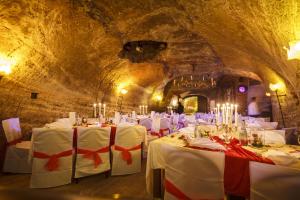 a dining room with white tables in a cave at Rebgarten Hotel Adler in Pfullendorf
