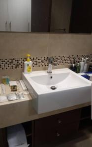 a bathroom with a white sink and a mirror at شقة خاصة برج رافال in Riyadh