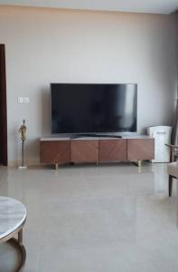 a living room with a large flat screen tv at شقة خاصة برج رافال in Riyadh