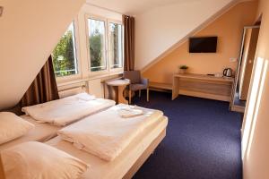a hotel room with two beds and a window at Ośrodek Chrobry in Pokrzywna +19 photos