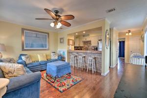 a living room with a couch and a ceiling fan at Convenient PCB Condo with Pool Access Walk to Beach in Panama City Beach