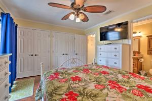 a bedroom with a bed and a ceiling fan at Convenient PCB Condo with Pool Access Walk to Beach in Panama City Beach