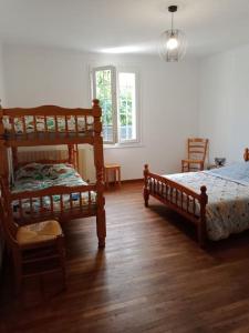 a bedroom with two bunk beds and a wooden floor at La POSADA in Ibos