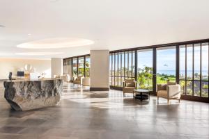 a lobby of a hotel with a large room with windows at Los Jardines de Abama Suites in Guía de Isora