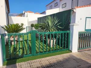 a green fence in front of a house at MaraVillas de Tenerife in Abades